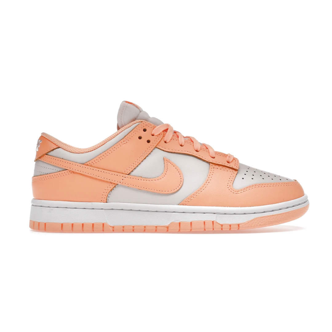 Achieve a fashionable look with Nike Dunk Low Peach Cream! This stylish, low-cut sneaker showcases the perfect blend of comfort and style with its breathable mesh and leather upper. With its crisp design, this sneaker is sure to make a statement! Be bold and make a statement with the Nike Dunk Low Peach Cream!