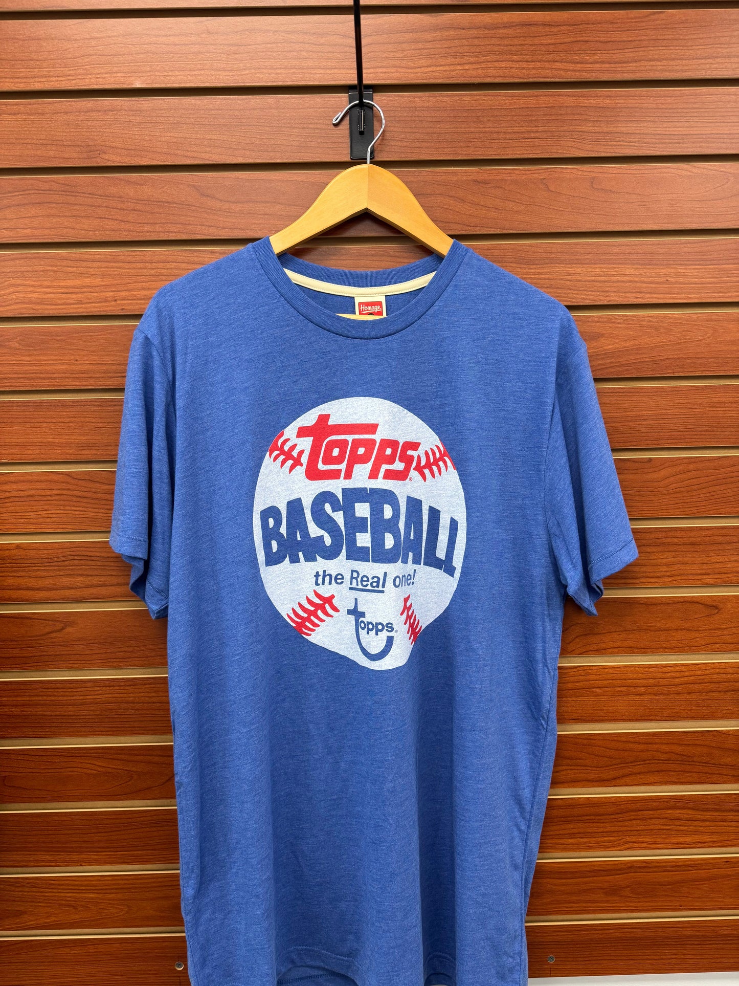 Show your passion for baseball with the Topps Homage Baseball The Real One Blue T-Shirt. Crafted for comfort and style, this shirt features a classic design that honors the sport’s rich history. Its vibrant blue color and authentic graphics make it perfect for game days or casual wear, helping you stand out while celebrating your favorite pastime. Durable and breathable, it’s an ideal choice for fans who want to combine nostalgia with everyday comfort.