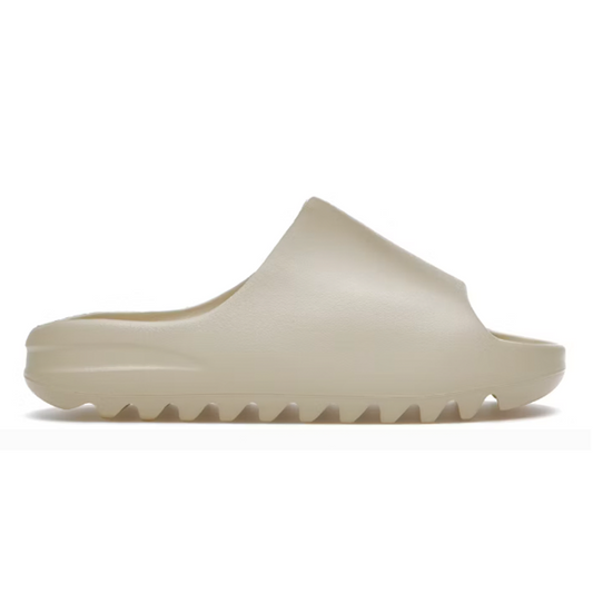 Introducing the Yeezy Slide Bone, your new must-have comfortable streetwear. Enjoy its unique style and feel the difference as you slide into this chic and luxurious design. Feel inspired and add a touch of luxury to everyday style. Welcome the Yeezy Slide Bone into your closet!