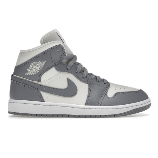 Step into style in the Nike Air Jordan 1 Mid Sail Stealth White (Womens). Designed with classic elements, these shoes feature Nike Air cushioning for all-day comfort. With a clean silhouette, these bold kicks will take you from day to night in style and comfort.