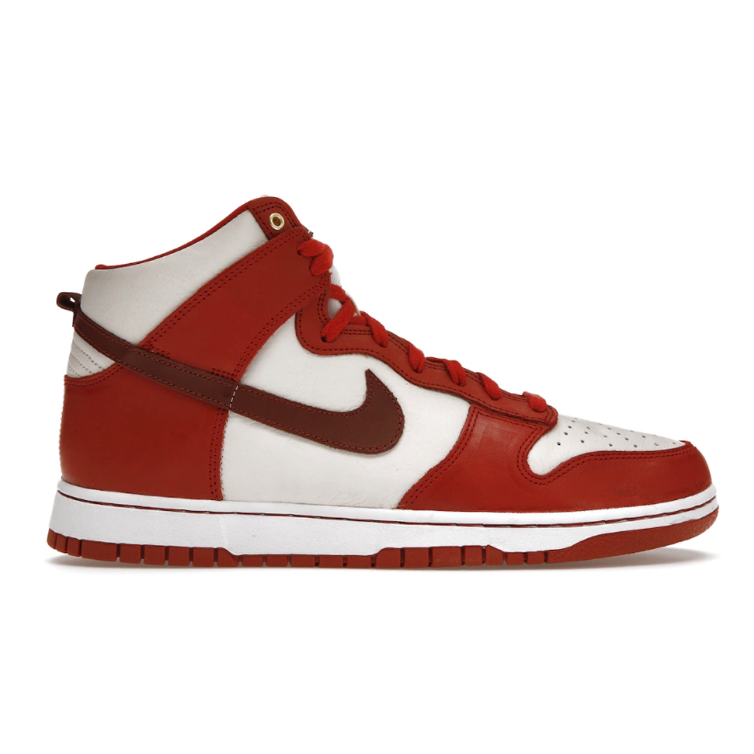 Get ready to stand out in the Nike Dunk High Cinnabar! This stylish sneaker features bold cinnabar and white hues that will add an energizing flair to any outfit. Comfort meets style with modern cushioning and a supportive design that will take your look to the next level. Seize the day in the Nike Dunk High Cinnabar!