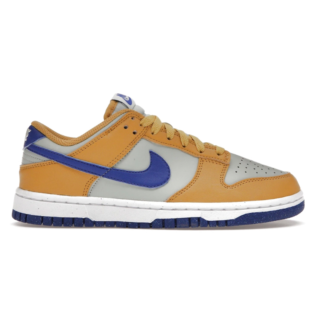 Take your style game up a notch with the Nike Dunk Low Next Nature Wheat Game Royal for Women. With a blend of wheat and game royal colors, this sneaker features premium leather uppers and is designed to deliver stylish comfort that lasts all day. Show your off your creative style!