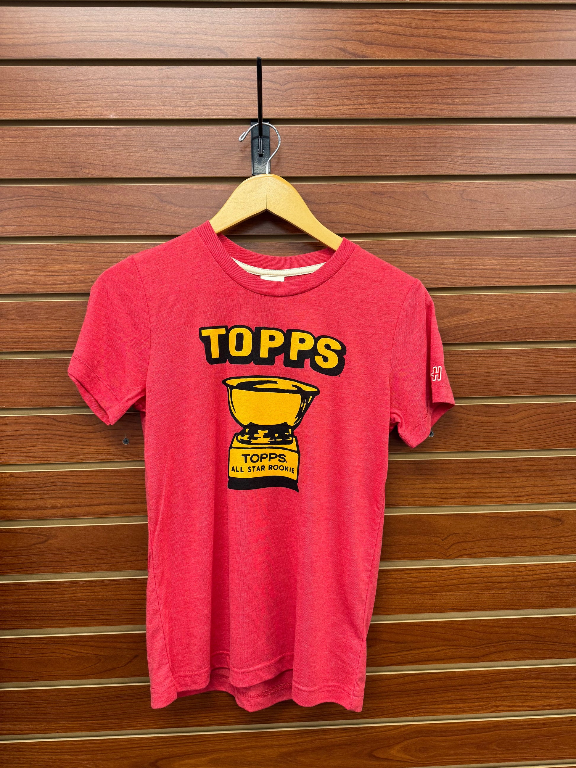 Celebrate your young sports fan’s passion with the Topps Homage All-Star Rookie Red Youth Tee. Designed for comfort and style, this vibrant red tee showcases a classic all-star rookie theme that inspires pride and enthusiasm. Perfect for everyday wear or game day, it offers a soft, durable fit that keeps up with active kids. Let your child stand out and show their love for the game in this standout youth tee.