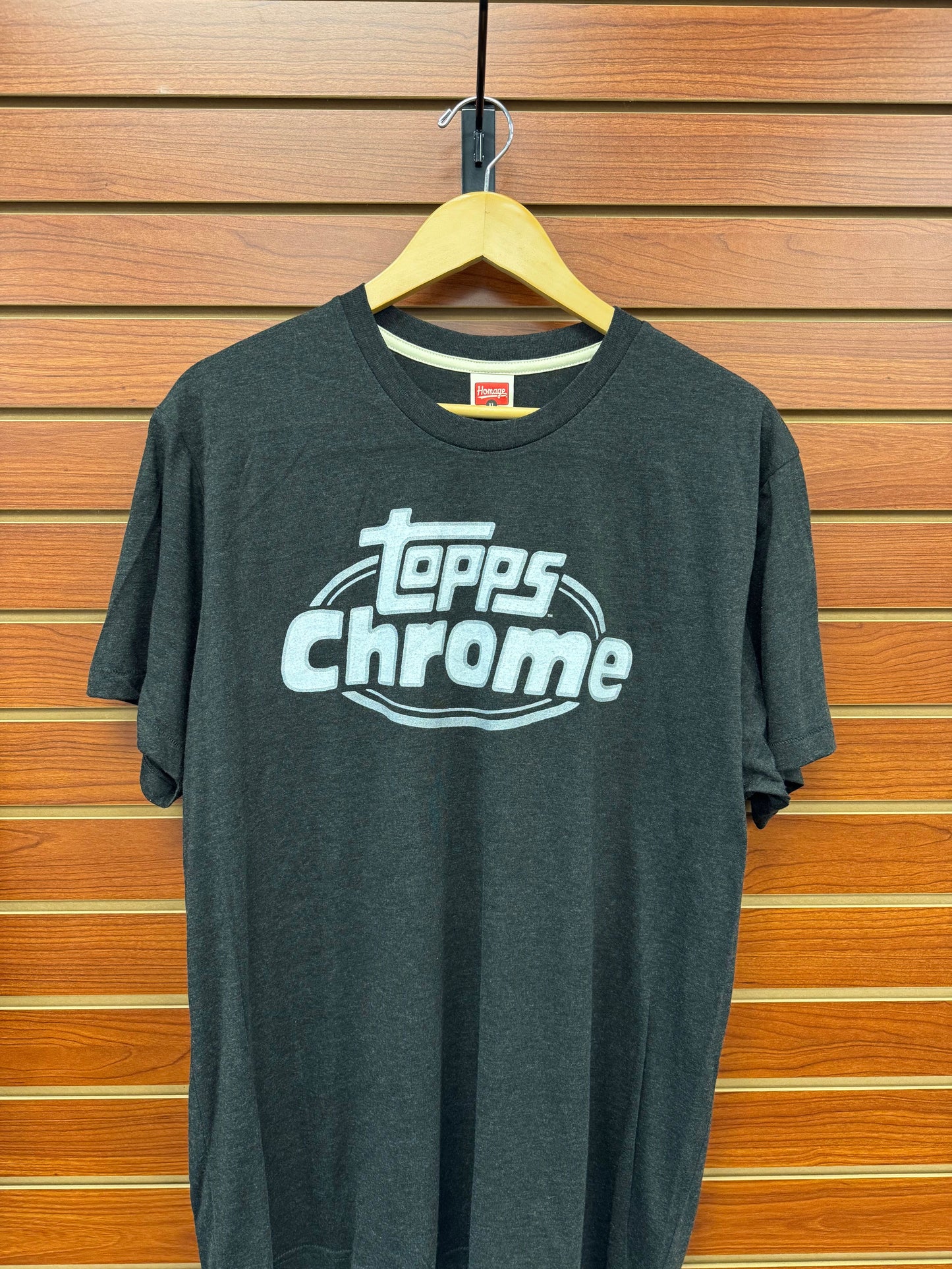 Elevate your casual wardrobe with the Topps Homage Topps Chrome Black Tee. Crafted for comfort and style, this tee features a sleek black design inspired by the iconic Topps Chrome set. Perfect for fans and fashion enthusiasts alike, it offers a versatile look that pairs effortlessly with any outfit. Experience premium quality and standout style in one essential piece.