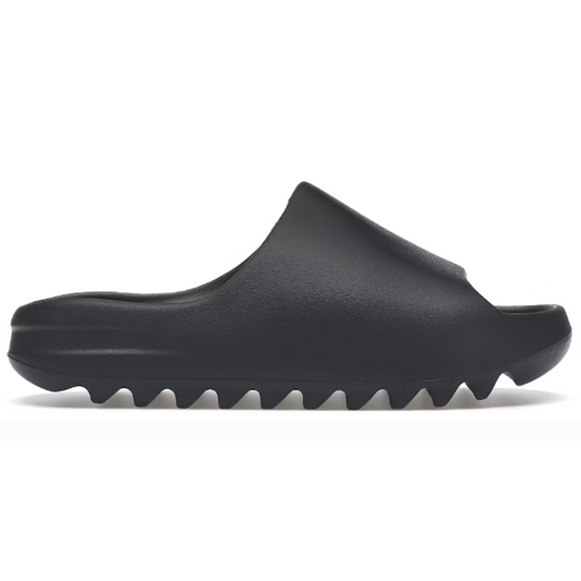 Step out in comfort and style with a pair of Yeezy Slides in Slate Grey. The perfect mix of fashion and function, these lightweight foam sandals feature a breathable upper band and flexible outsole for ultimate comfort and movement. Elevate your look and feel confident all day with these must-have slides.